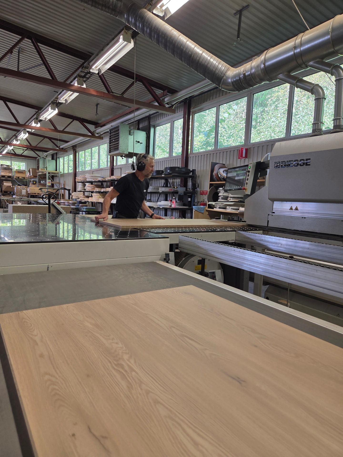 Medarbetare vid BIESSE-maskin i Rakamas fabrik